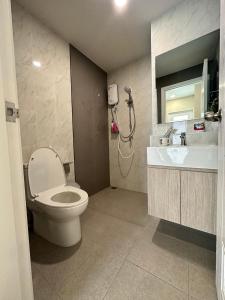 a bathroom with a toilet and a sink and a shower at The East Ville in Ban Hua Khao Sammuk