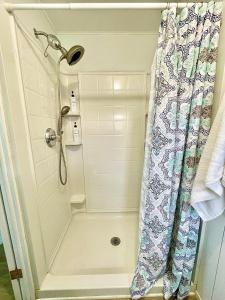 a shower in a bathroom with a shower curtain at Tropical Oasis near beach in Naples