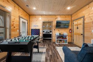 a room with a foosball table and a bedroom at NEW/KING Bed/GAME room/HOT TUB/Central location in Sevierville