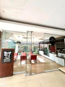 a restaurant with red chairs and tables in a building at CF Haven - Resort Living Condo w/ Balcony at Bamboo Bay in Mandaue City