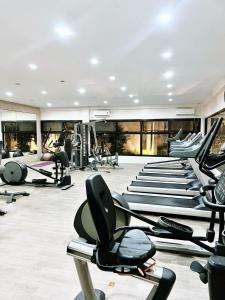 un gimnasio con cintas de correr y sillas en una habitación en CF Haven - Resort Living Condo w/ Balcony at Bamboo Bay, en Mandaue