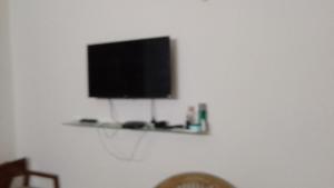 a flat screen tv on a wall with a shelf at 2BHKapartment-Calm and natural in Faridabad