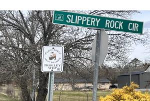 a street sign for slippery rock street with a sign at 3 Master Bedrooms - Sleeps 10 - Location - Game Room - Hot Tub in Pigeon Forge