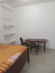 Habitación con mesa, sillas y cama en Sena Home, en Ambalangoda