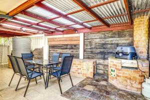 a patio with a table and chairs and a grill at Avalon 2 in Nambucca Heads