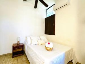 Un dormitorio con una cama con una cesta. en CABO BOHEMIA Tropical Garden Studios, en Cabo San Lucas