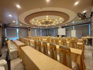 a conference room with tables and chairs in it at Hồng Nhung Hotel Kiên Giang in Rạch Giá