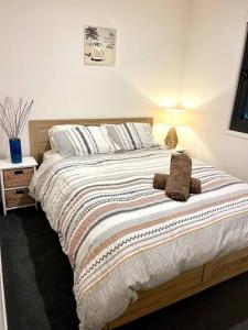 a bed with a stuffed animal sitting on top of it at Casa De Mork - Entire 3 Storey Beach Villa in Gold Coast