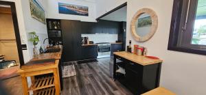 A kitchen or kitchenette at MOOLOOLABA CANAL HOME - Modern 4Bedroom with Spa, Sauna and Private Pontoon - NEW proprietor 2024