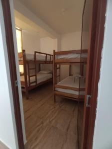 a room with two bunk beds and a doorway at CARDOS HOSTAL in Pisco