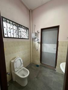 a bathroom with a toilet and a shower and a sink at Casa Lily Residence IM8 in Kuantan