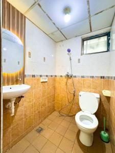 a bathroom with a toilet and a sink at Beranda Istirahat 2BR Laguna Pluit in Jakarta