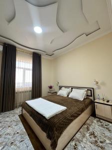 a bedroom with a large bed with a coffered ceiling at Aral in Nukus +32 photos