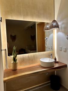 a bathroom with a sink and a large mirror at Casa Bicachi - Adults Only in Puerto Escondido