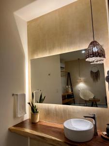 a bathroom with a sink and a mirror at Casa Bicachi - Adults Only in Puerto Escondido