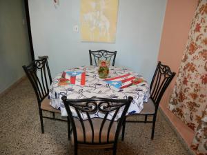 a dining room table with a table and two chairs at Brisas de Borinquen in Aguadilla