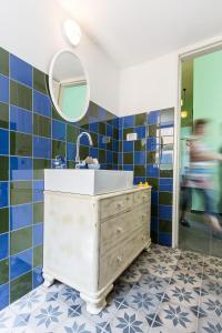 a bathroom with a sink and a mirror at Sea&stone Apartment in Haifa