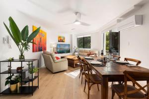 a dining room and living room with a table and chairs at Walking Distance to Darling Harbour in Sydney