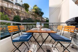 a table and chairs sitting on a balcony at Walking Distance to Darling Harbour in Sydney