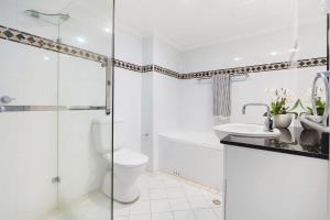 a bathroom with a shower and a toilet and a sink at Walking Distance to Darling Harbour in Sydney