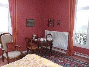 a dining room with a table and two chairs at Le Clos Domremy in Domrémy-la-Pucelle