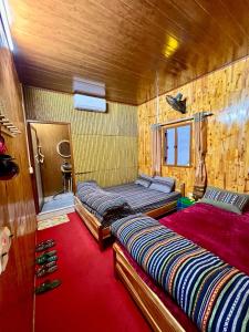 een slaapkamer met 2 bedden en een rode loper bij Pura Homestay in Na Thôn