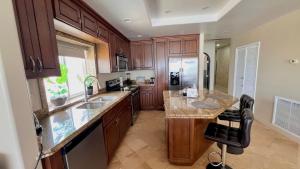 a kitchen with wooden cabinets and a counter top at Beautiful Beach Front Condo near Downtown in Rosarito