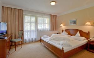 Postel nebo postele na pokoji v ubytování Hotel Waldheim Garni