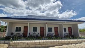 a small house with a blue roof at J & L Apartelle in Moalboal