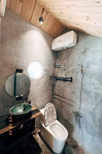 a bathroom with a sink and a toilet in it at A Nhà House in Xuân Trường