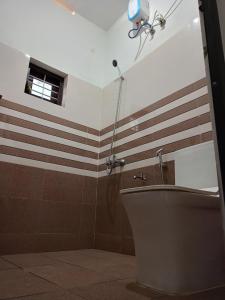 baño con aseo y ventana en Enna homestay, en Varkala