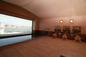 a large room with a large window and a swimming pool at 湘南江の島　御料理旅館　恵比寿屋 in Fujisawa