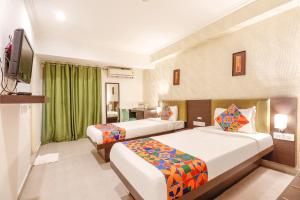 Postel nebo postele na pokoji v ubytování FabHotel Park Inn - Indiranagar + 25 fotografií