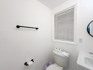 a white bathroom with a toilet and a sink at 2-BDRM Fort Lauderdale - Las Olas Beach 5 minutes walk #5 in Fort Lauderdale