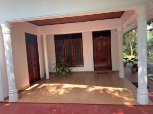 an entry to a house with two entry doors at Pinnawala Grand Villa in Rambukkana