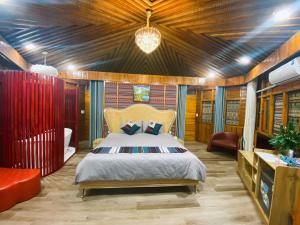 a bedroom with a bed and a couch in a room at SaPa Sinai Homestay in Sapa