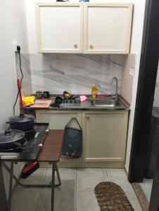 a small kitchen with a sink and a stove at ZED Hostel (Mix Share Studio) in Abu Dhabi