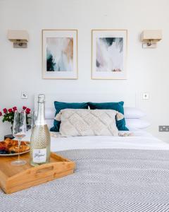 a bedroom with a bed with a bottle of wine on a tray at Stunning 1 Bed apartment Kings Cross/St Pancras Farringdon in London