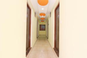 a corridor of an office building with columns and orange lights at FabExpress Shanel Beachside Resort in Baga