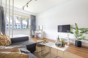 a living room with a couch and a table at Frank Porter - Lake Apartment in Dubai