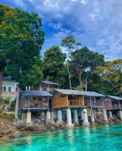 a house on a island in the water at Olala Bungalows and Restaurant in Sabong