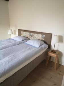 a bedroom with a bed with two pillows and a table at Foxhouse in Præstø