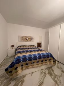 a bedroom with a large bed in a white room at Andrea's holydays in Roquebrune-Cap-Martin