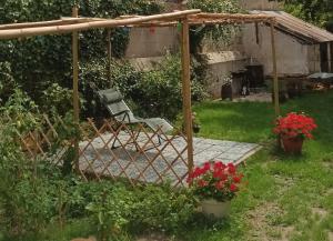 a chair under a gazebo in a garden at Coup de cœur en Brenne in Martizay