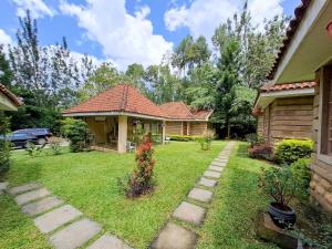 a house with a grass yard with a house at Od Kidi Cottages in Migori