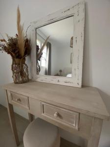 a mirror sitting on top of a dressing table at Casa Fondale in Santa-Reparata-di-Balagna