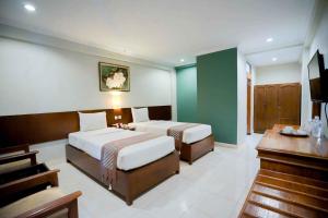 Postelja oz. postelje v sobi nastanitve Cakra Kembang Hotel
