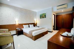 Postelja oz. postelje v sobi nastanitve Cakra Kembang Hotel
