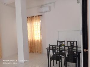 une salle à manger avec une table et des chaises noires dans l'établissement SP 4 Homestay Kuranji Kota Marudu Sabah Malaysia, à Kampong Sorosob