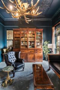 a living room with a couch and a chandelier at Victoria and Albert Guesthouse in Mount Victoria